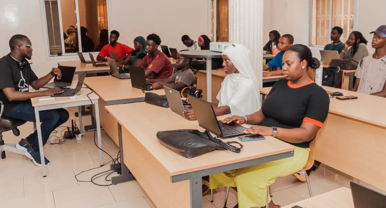 Instructor leading a hands-on coding class at Jasseh Code Camp